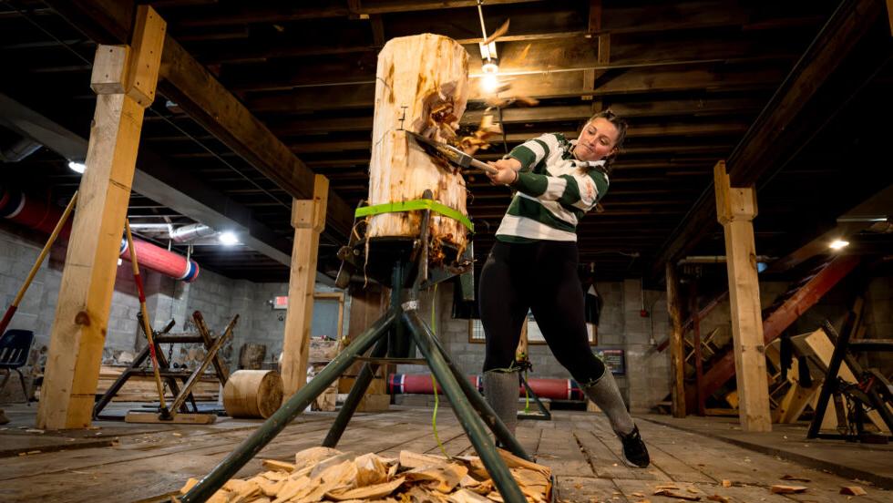 Student chopping a log with an axe